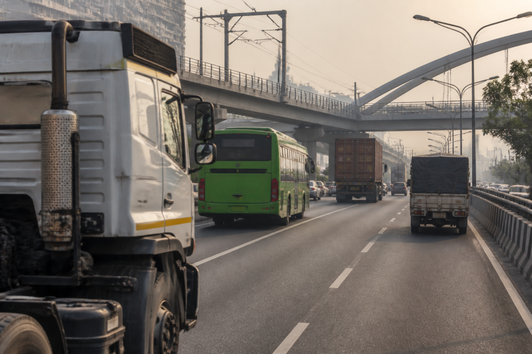 Heavy commercial vehicles on a Delhi-NCR road, illustrating the vehicle emissions retrofit and fleet replacement policy