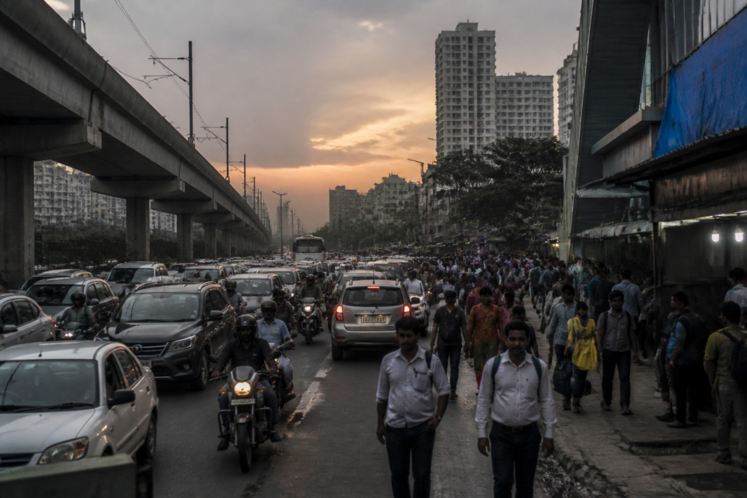 Busy Indian city traffic and dense urban surroundings illustrating the debate over India GDP growth and lived prosperity