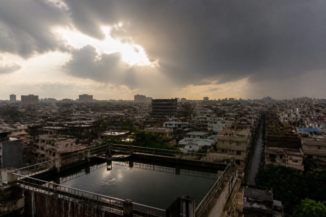Urban India under intense heat and dark monsoon clouds, illustrating El Nino India climate risks