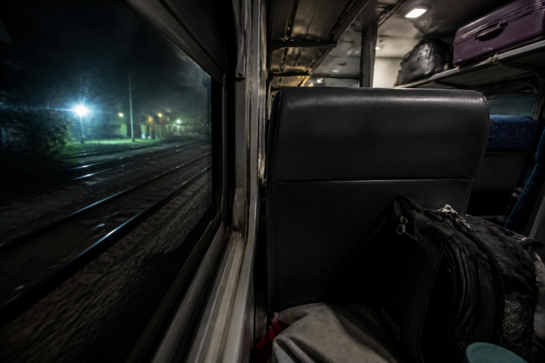 Passengers inside an Indian express train during a night journey, illustrating train theft and railway passenger safety concerns
