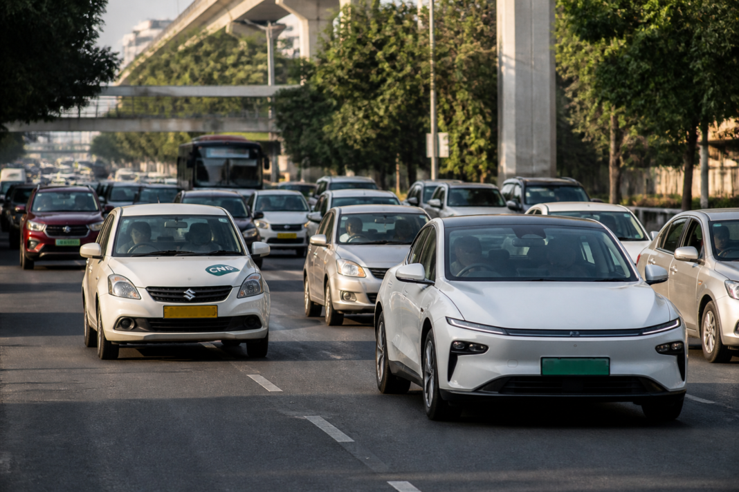 Cars representing India’s changing passenger-vehicle market on an urban road, including an electric vehicle and a CNG car
