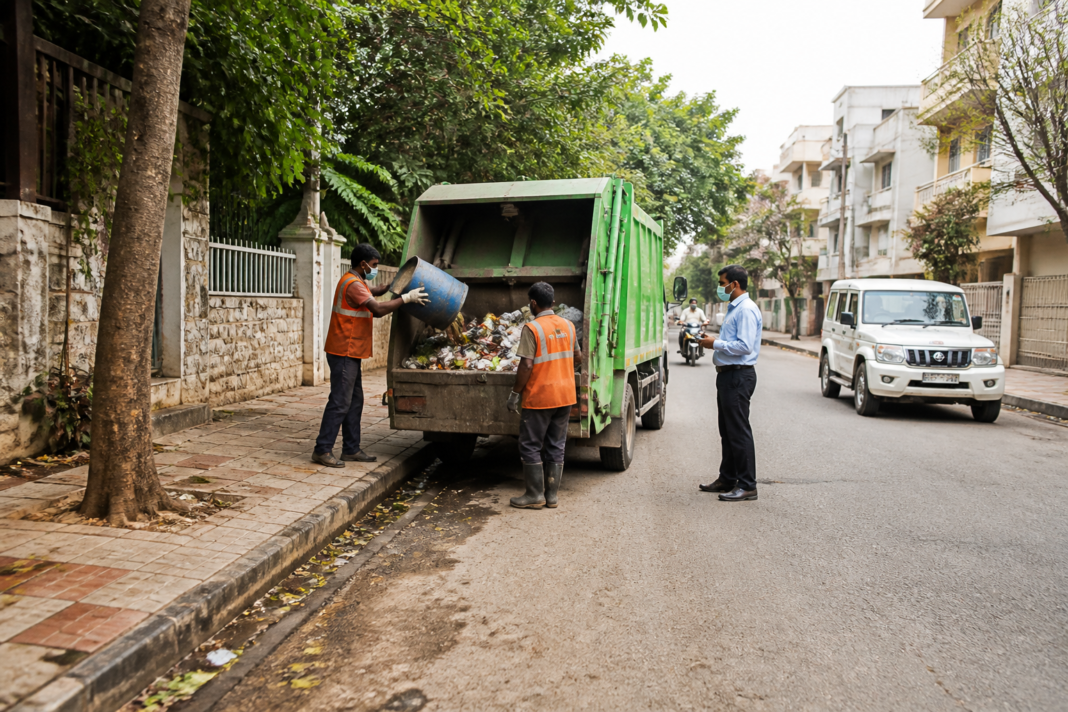 Civic workers and waste collection infrastructure in Bengaluru during an inspection of the city's East Division