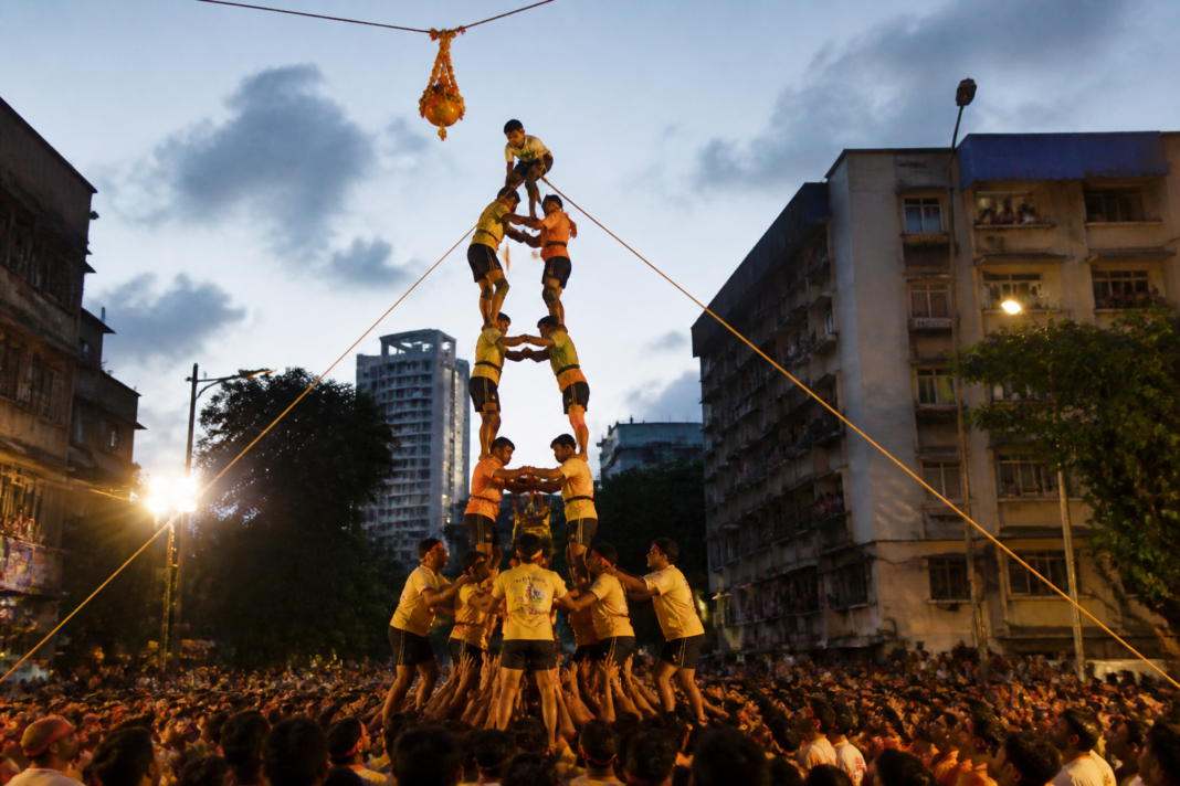Dahi Handi Govinda teams forming a human pyramid during a festival in Thane