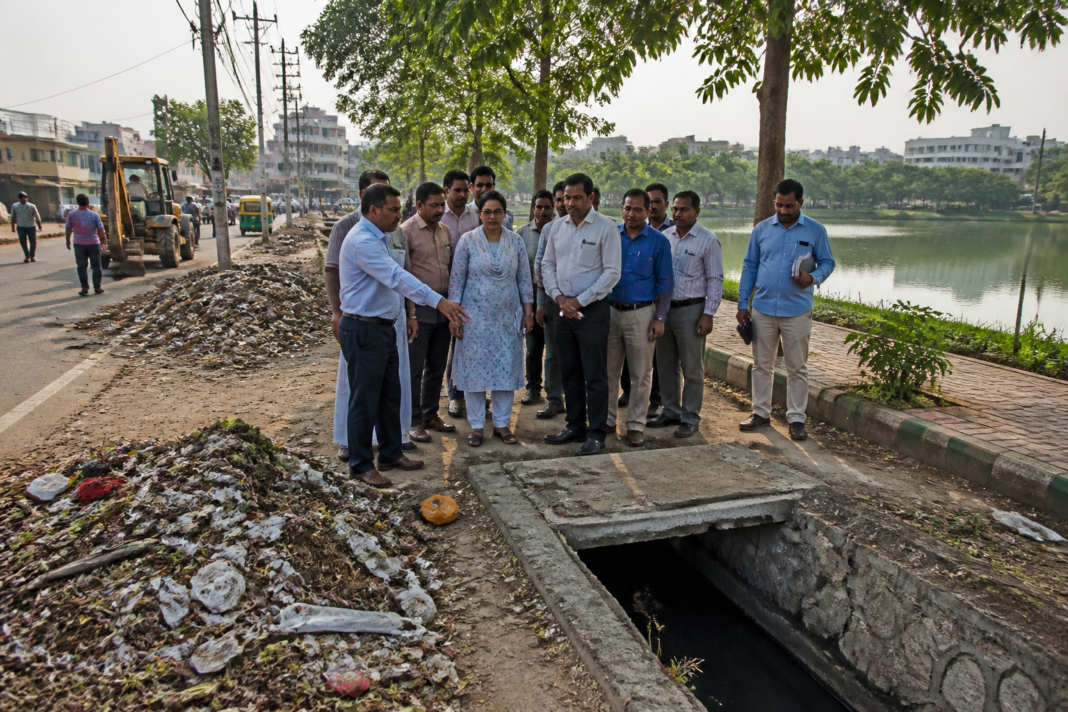 Civic workers and officials inspecting waste management and public infrastructure in Bengaluru