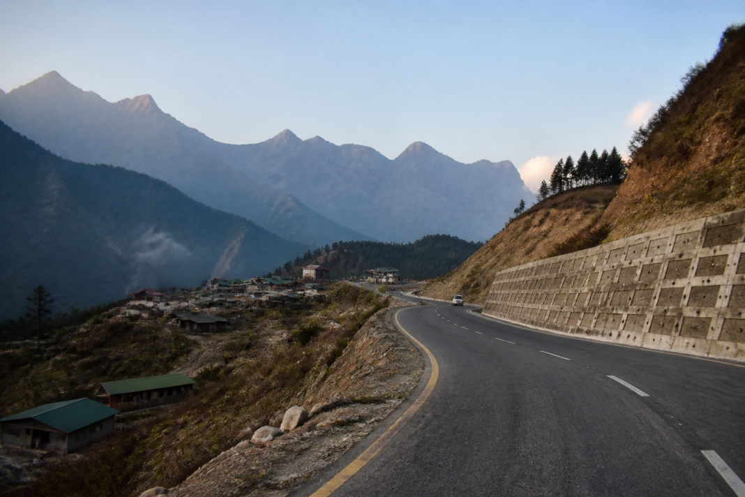 Mountain road and border infrastructure in Arunachal Pradesh showing connectivity through a remote Himalayan landscape