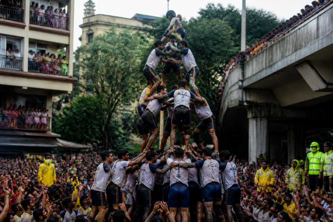 Govinda participants forming a human pyramid during a Dahi Handi celebration in Thane