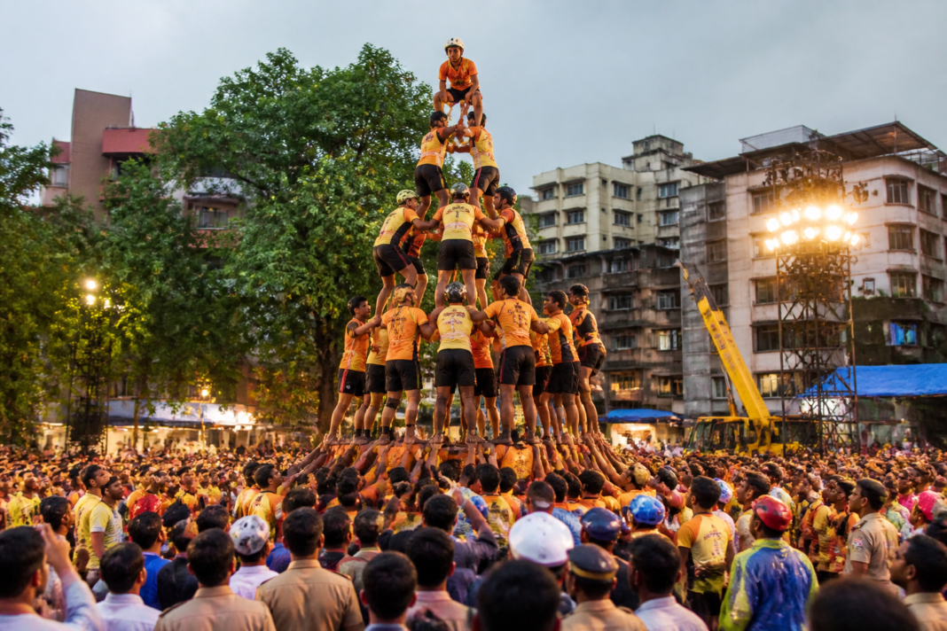 Govinda teams forming a human pyramid during a Dahi Handi celebration at Tembhi Naka in Thane