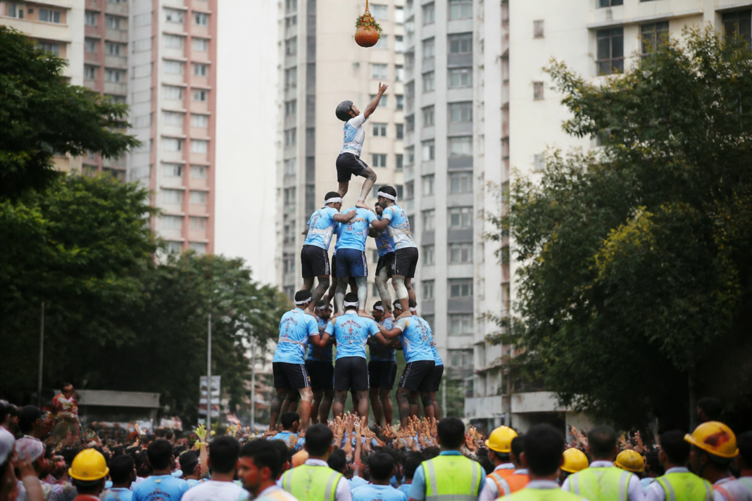 Govinda teams forming a human pyramid during a Dahi Handi celebration in Thane, illustrating the safety risks associated with Dahi Handi accidents