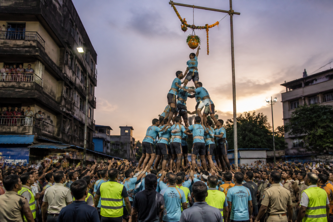 Govinda participants forming a human pyramid during a Dahi Handi celebration in Vasai-Virar