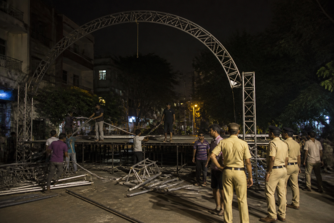 Temporary Dahi Handi event stage structure being dismantled at night in Old Sangvi, Pimpri-Chinchwad
