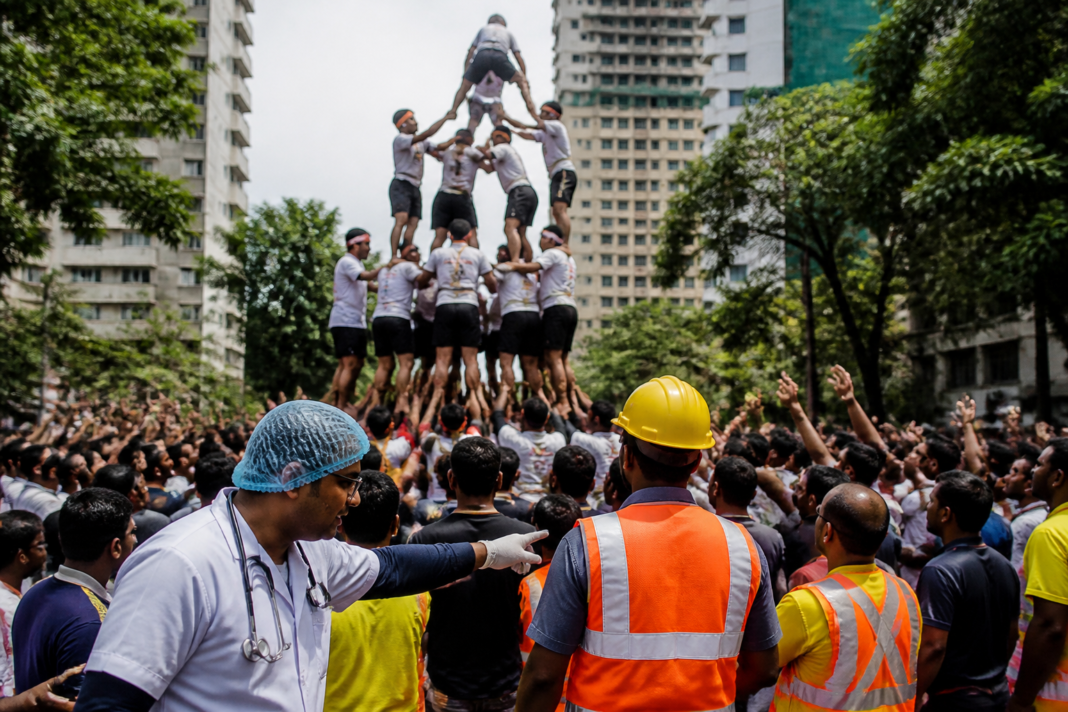 Govinda participants forming a human pyramid during a Dahi Handi festival in Thane