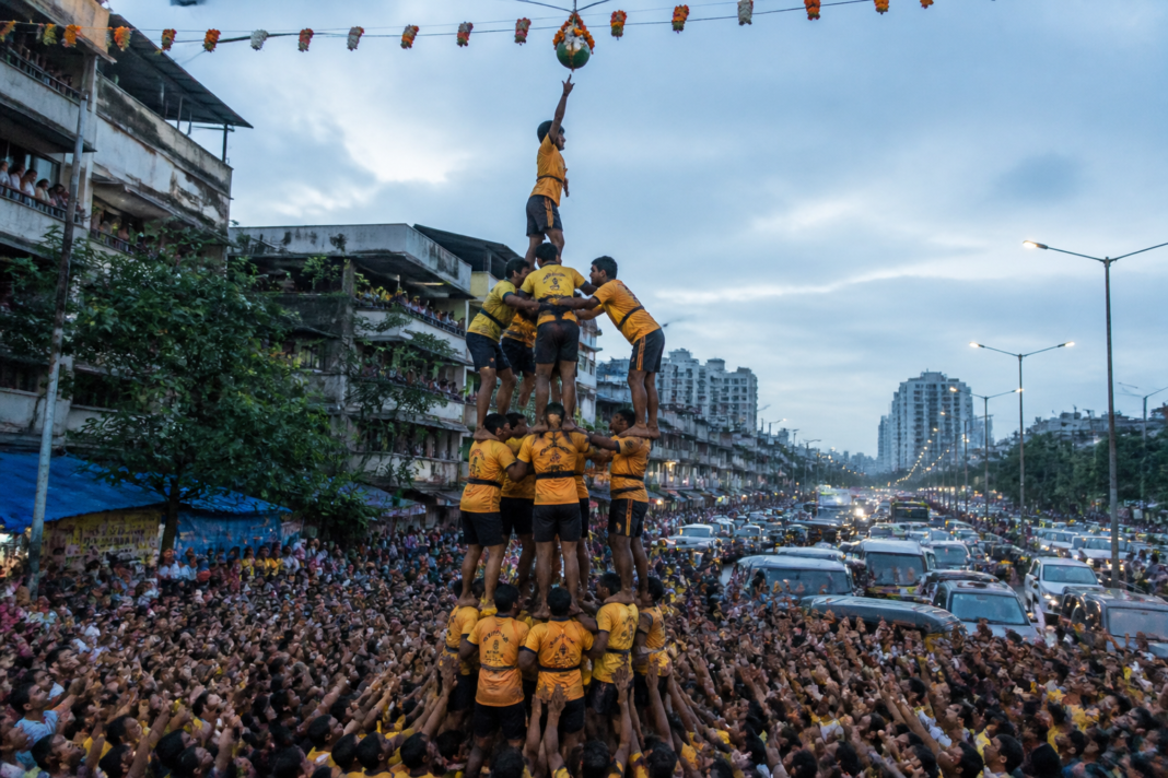 Govinda team forming a human pyramid during a crowded Vasai-Virar Dahi Handi celebration
