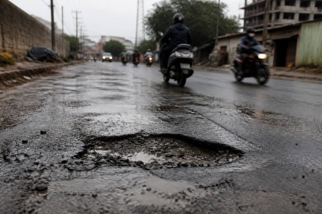 Road with potholes in Varthur, Bengaluru, illustrating the reported pothole accident involving a two-wheeler rider