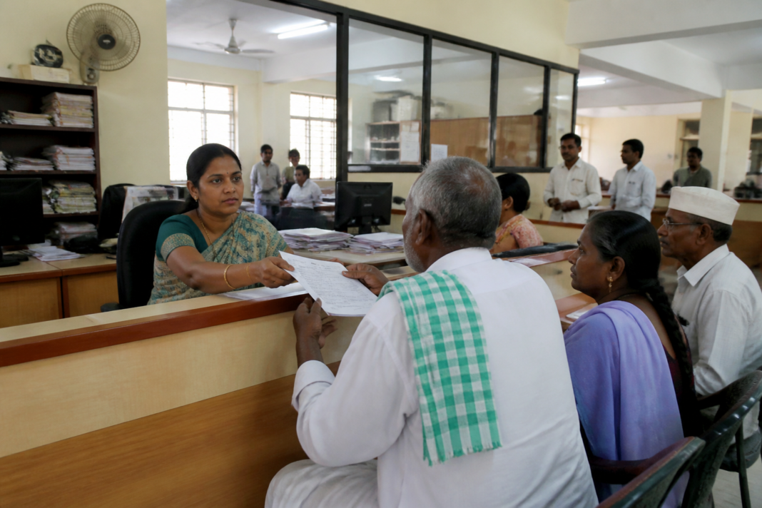 Officials receiving public grievances at a Praja Seva campaign meeting in Karnataka