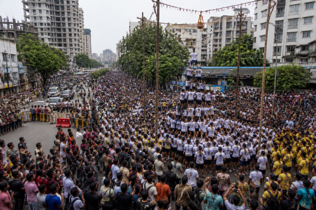 Govinda teams gather near a road closure during Dahi Handi celebrations in Thane