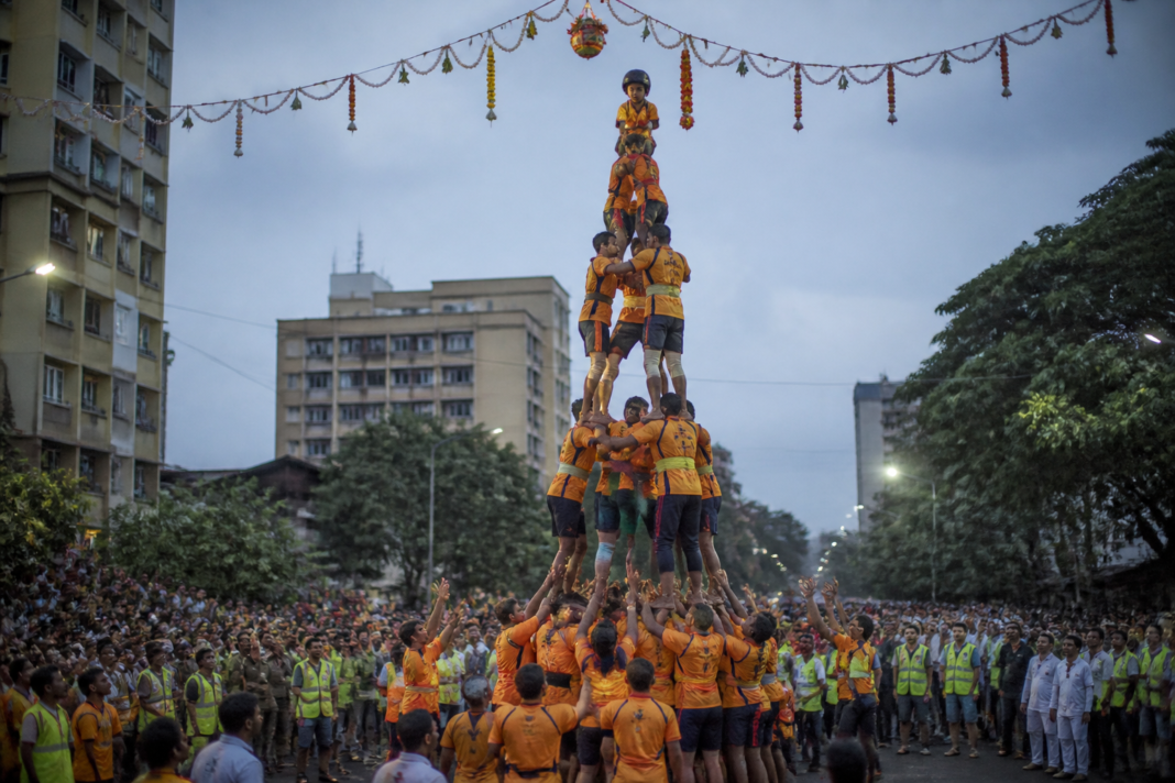 Govinda participants forming a human pyramid during a Dahi Handi celebration in Vasai-Virar