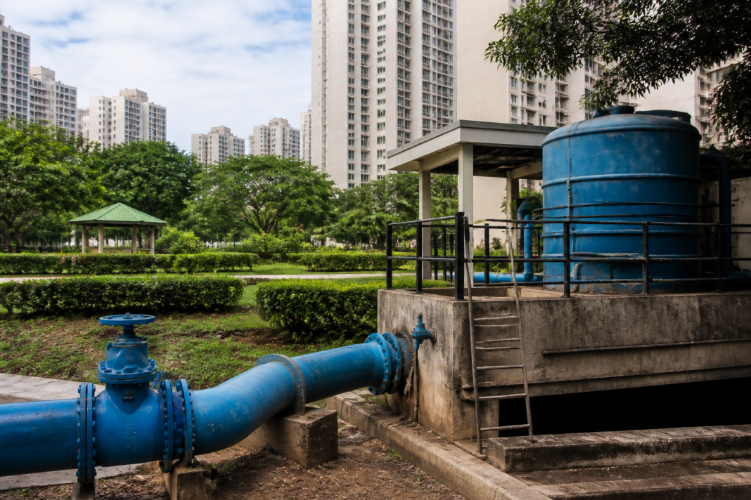 Bengaluru water security infrastructure showing a city water pipeline, rainwater harvesting system and urban buildings