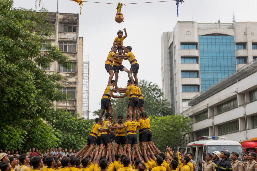 Govinda participants forming a human pyramid during a Dahi Handi event in Thane