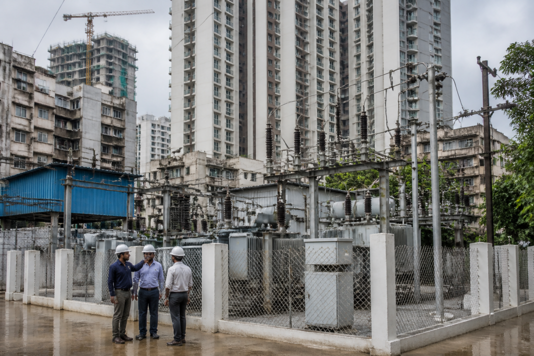 Electricity infrastructure serving a dense Mumbai residential redevelopment area, illustrating BEST’s drive to add new electricity customers