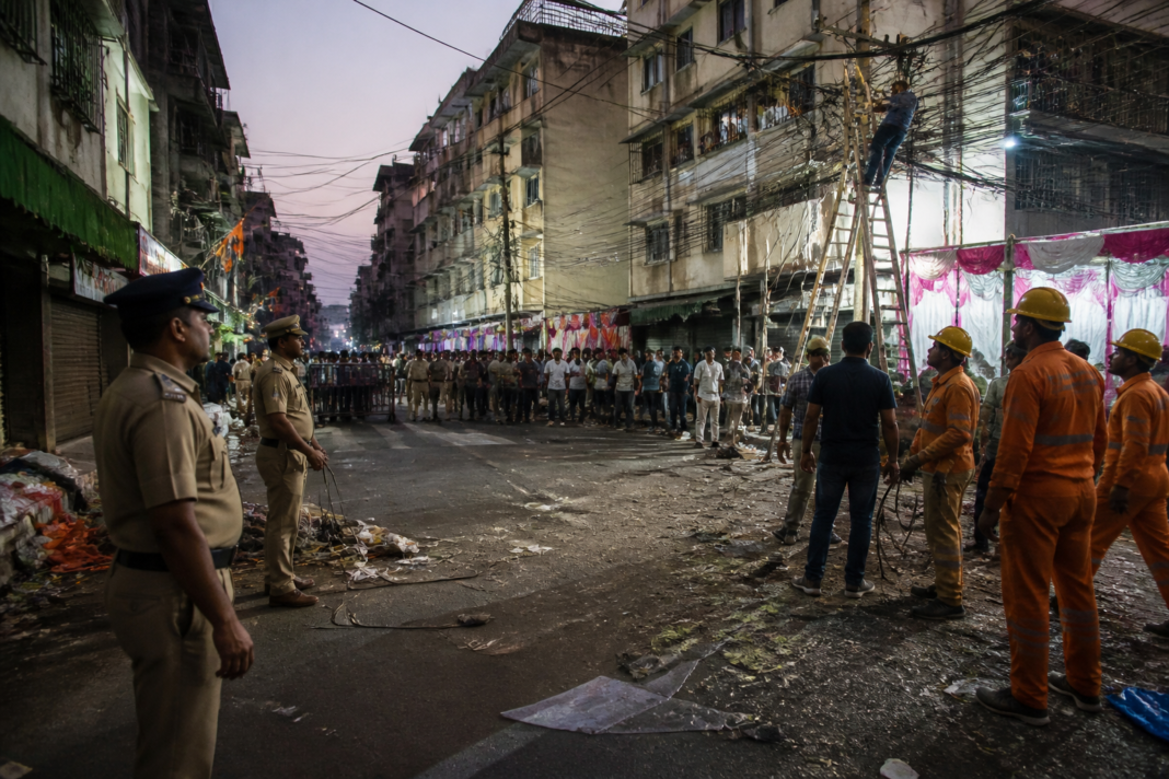 People gather near the Line Ali area in Panvel after an electrocution incident during a Dahihandi celebration