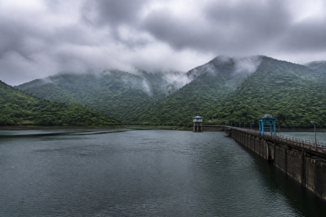 Mumbai reservoir water levels showing a full lake surrounded by monsoon greenery