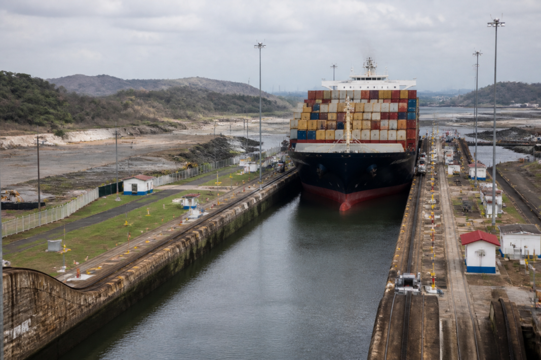 Panama Canal lock system and cargo ship transiting through a waterway affected by water shortages