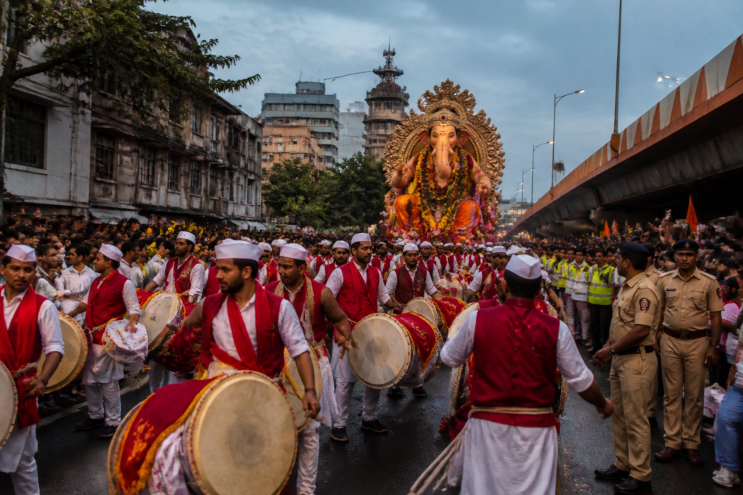 Ganeshotsav procession in Pune with traditional dhol-tasha performers and restrictions on DJ sound systems