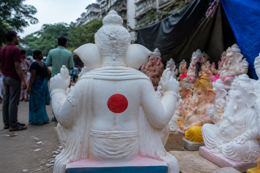 POP Ganesh idols displayed at a Vasai-Virar marketplace with red identification marks on their backs