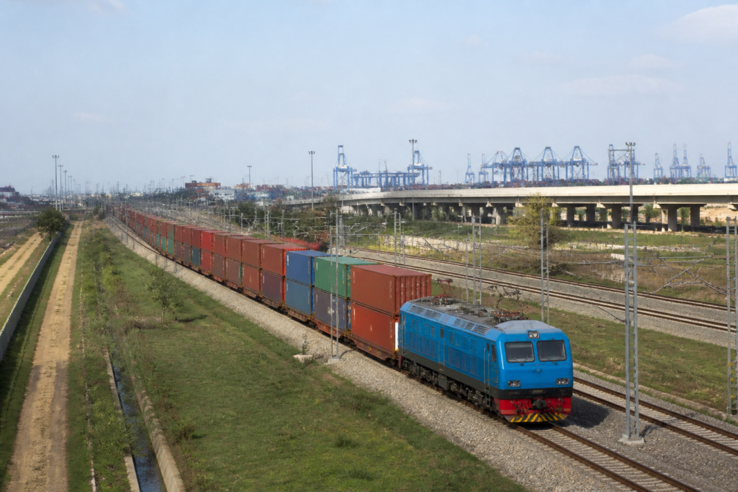 Freight train operating on India’s Dedicated Freight Corridor near industrial and port-connected infrastructure