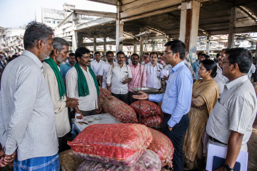 Farmers and traders at Bengaluru's Yeshwanthpur APMC market during a discussion on Karnataka crop insurance and market practices