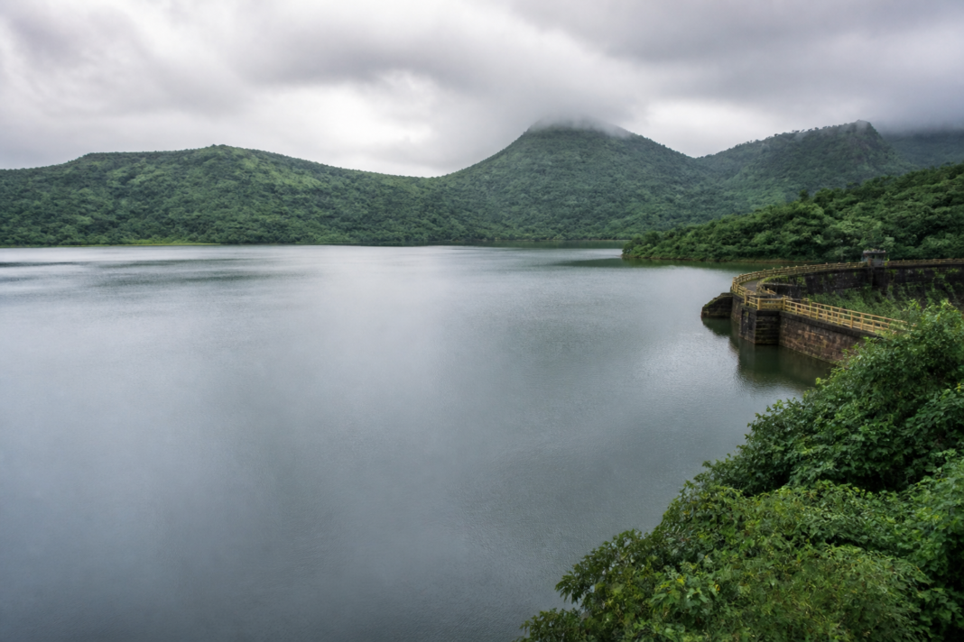 Mumbai lake supplying the city with water during the monsoon, with hills and overcast skies in the background