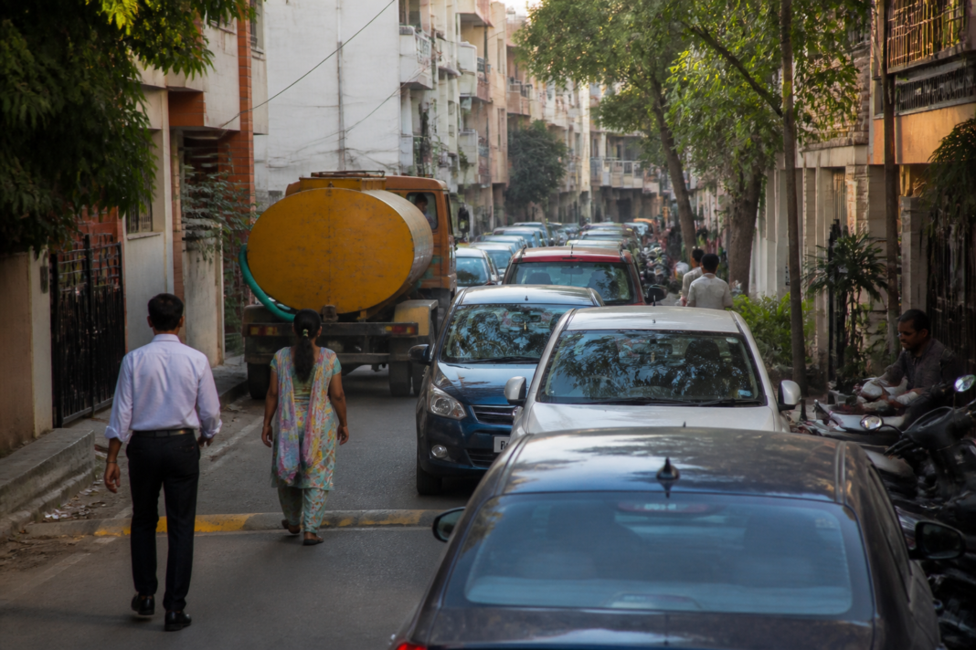 Traffic moving through a narrow residential lane in Bengaluru as residents navigate congestion and roadside safety concerns