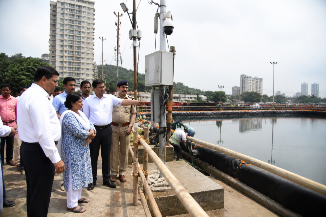 Workers and civic officials inspect Ganesh visarjan ghat preparations at a Thane immersion site