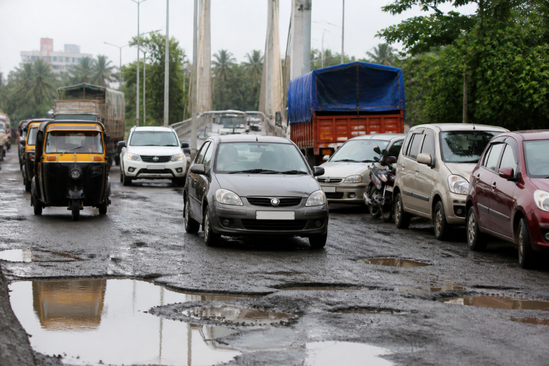 Traffic moving along a pothole-damaged Uran-Konkan route near the Khopate bridge