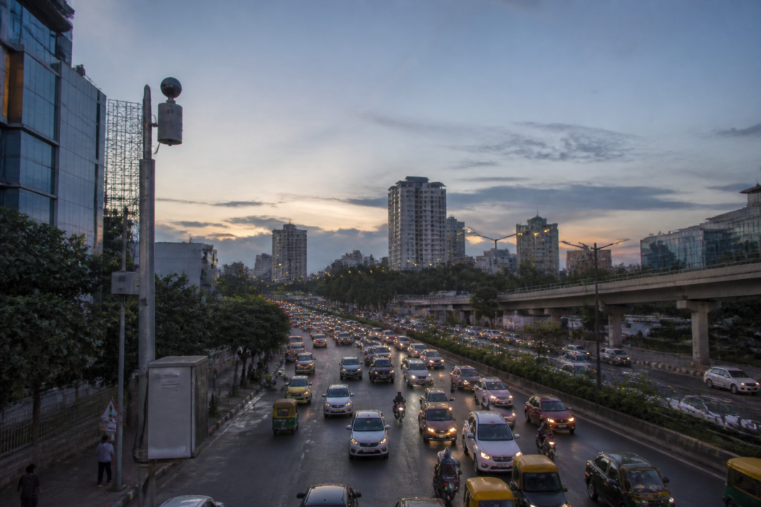 Traffic and urban activity near a Bengaluru road representing the city's noise pollution monitoring challenge