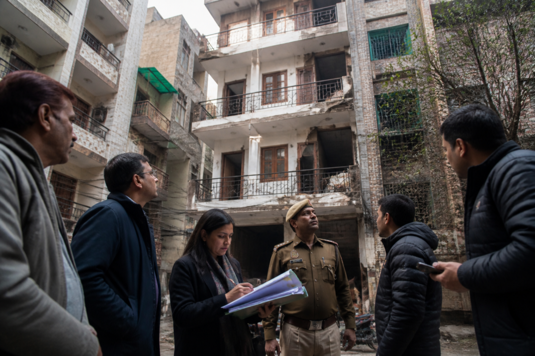 Municipal officials inspect a multi-storey building used for paying-guest accommodation in Delhi