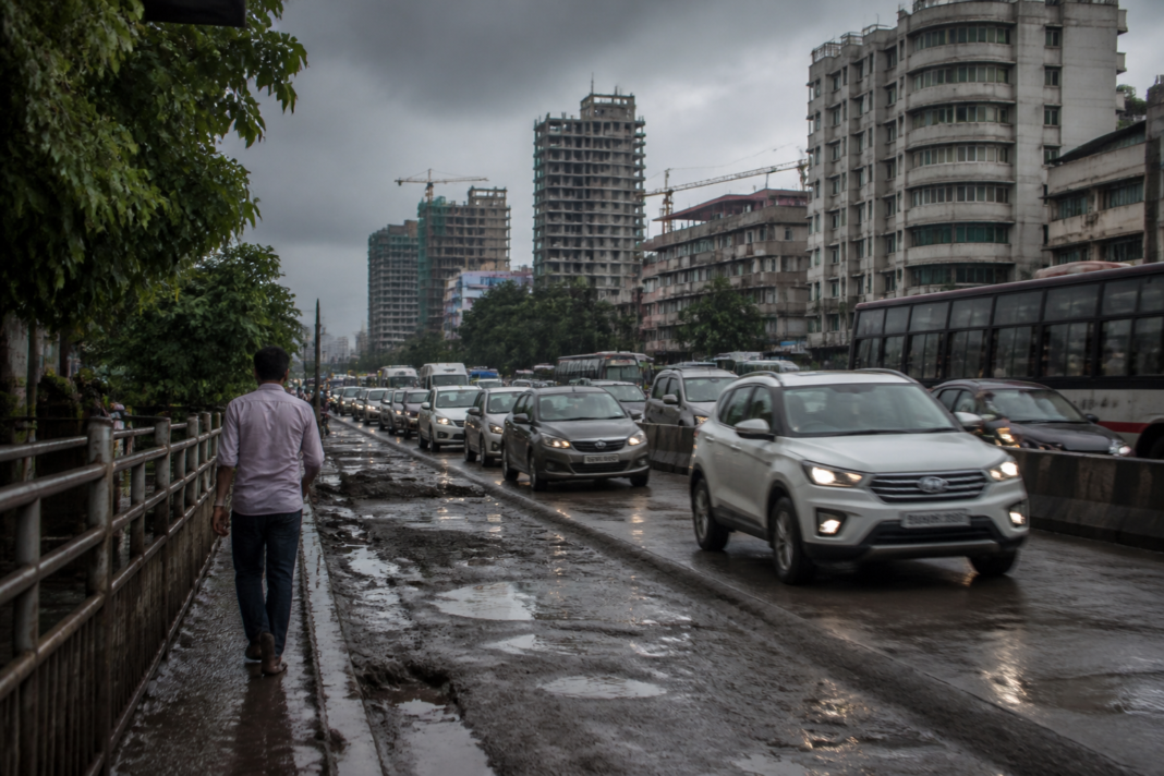 Urban crisis in India shown through a congested Pune road, dense construction and limited green space