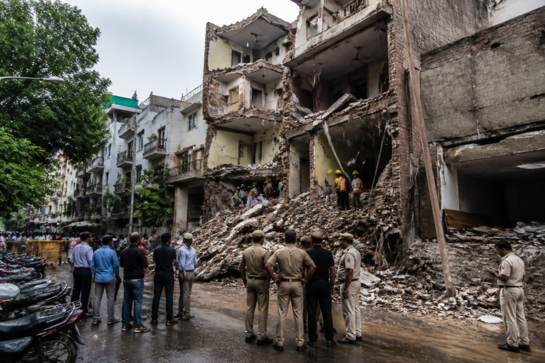 Delhi building collapse site in Satya Niketan amid urban construction and civic inspection activity