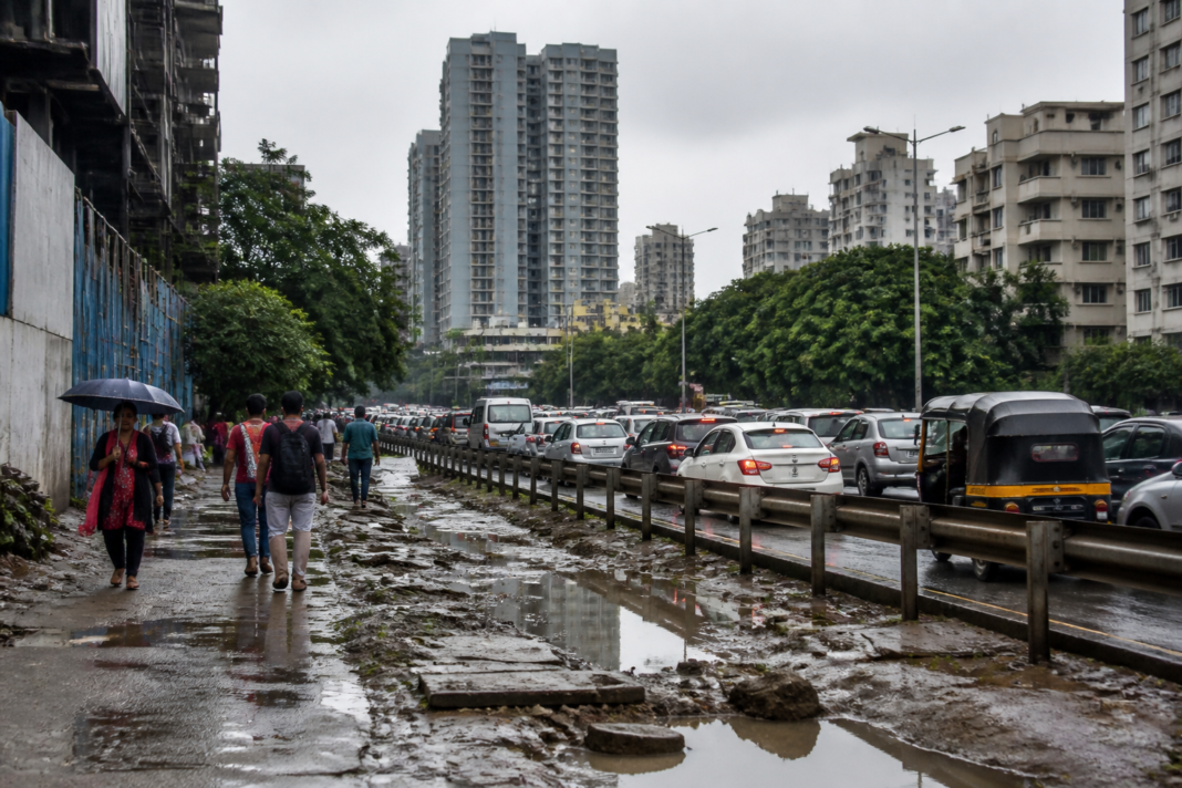 Urban crisis in Pune shown through congested roads, dense construction and climate-vulnerable city infrastructure.