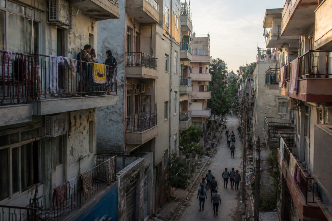 Dense Delhi PG accommodation buildings in a South Delhi neighbourhood with narrow balconies and shared residential spaces