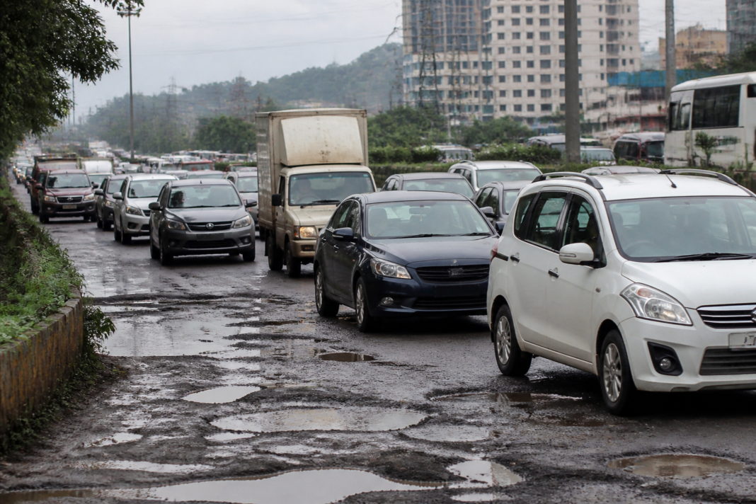 Traffic moving along the damaged Ghodbunder Road near Mira-Bhayandar before postponed repairs