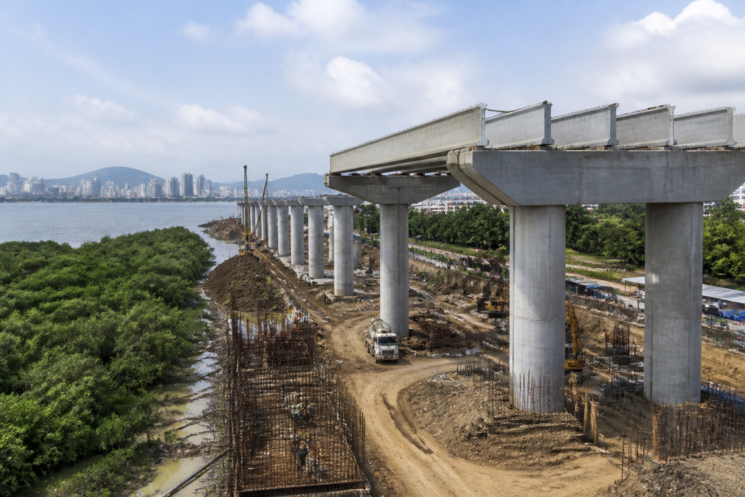 Construction of the Thane Coastal Road-1 elevated corridor with piers and girders near Thane Creek