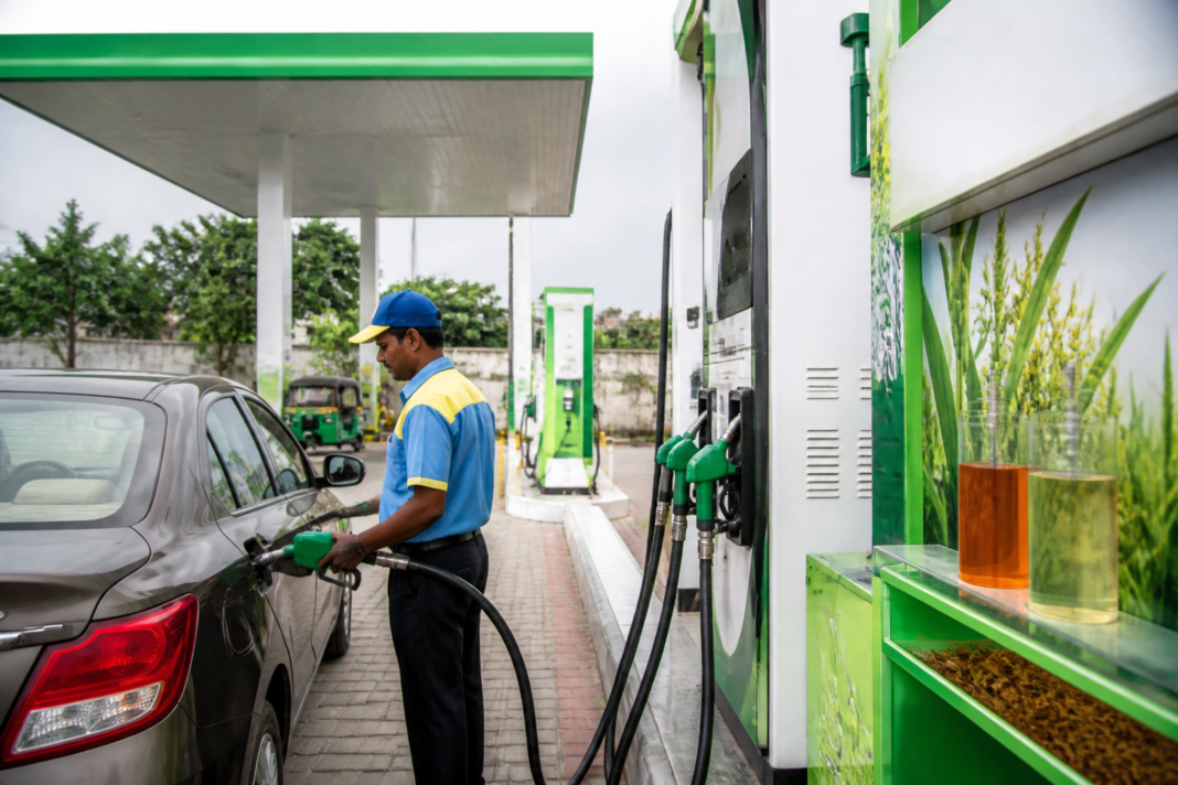 Fuel station in India with a vehicle refuelling beside pumps representing ethanol blending and flex-fuel transport