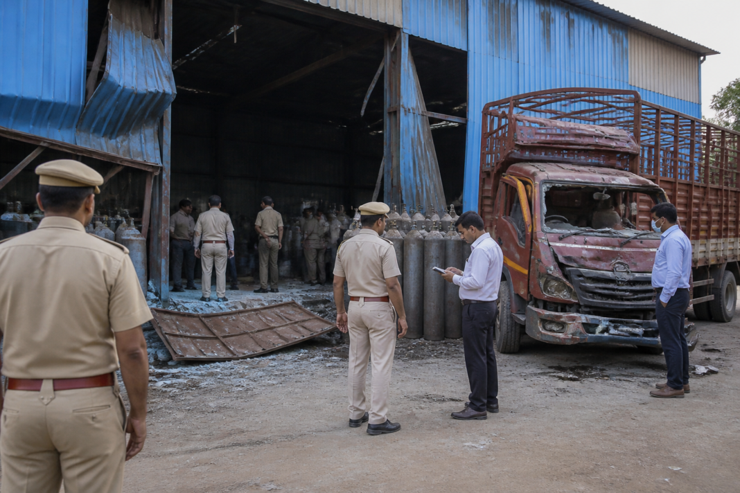 Police and emergency responders at an Okhla industrial godown after an oxygen cylinder explosion in Delhi