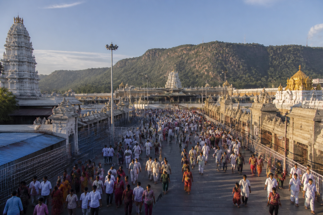 Devotees walking through the Tirumala temple complex, representing the TTD's new life insurance cover for pilgrims