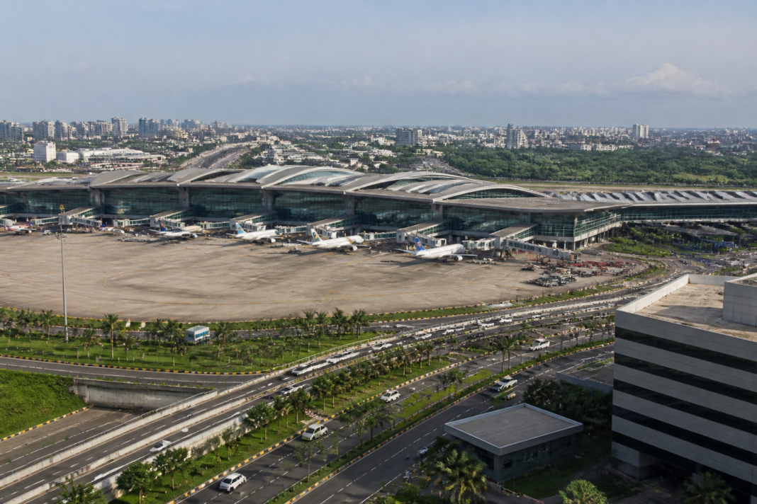 Airport terminal and surrounding urban development representing Adani Airports’ expansion strategy