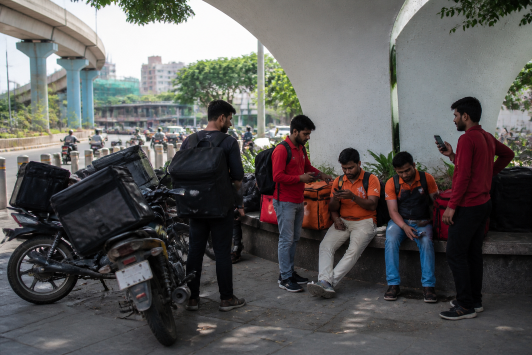 Gig delivery workers resting near an urban delivery hub in Hyderabad, illustrating the proposed Pragati Centres