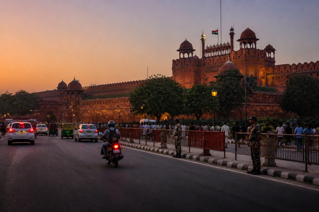 Security personnel and traffic moving near the Red Fort in Delhi after details from the Red Fort blast chargesheet emerged