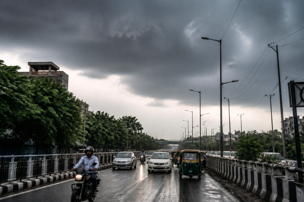 Rain clouds over an urban Delhi street during the IMD forecast period
