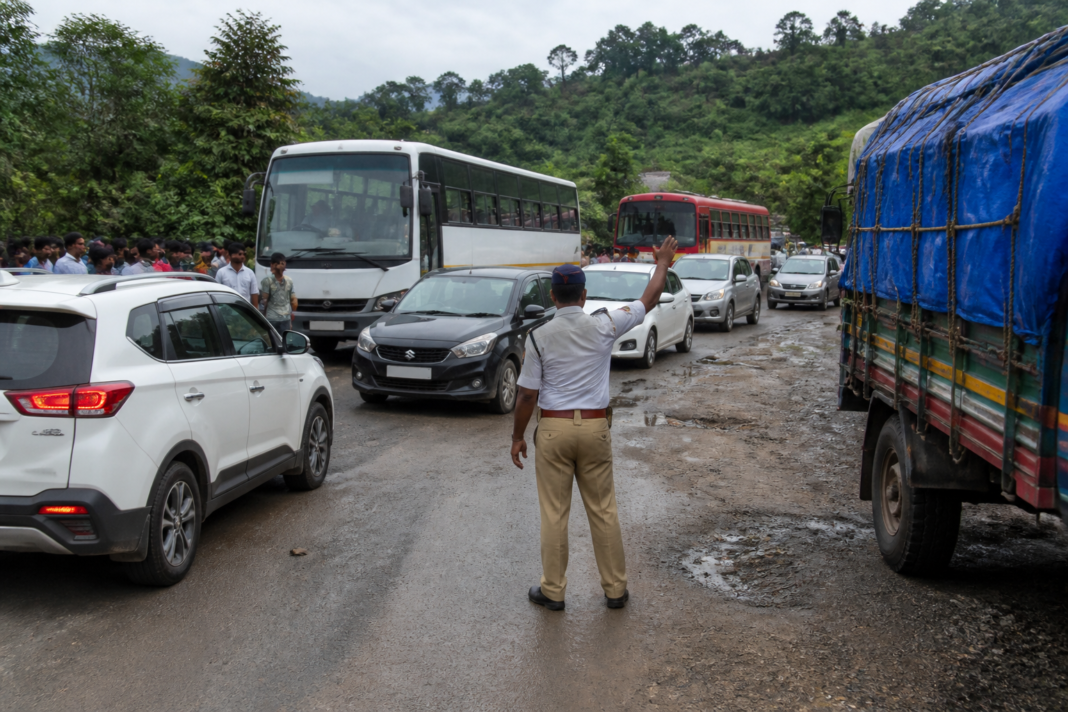 Traffic diversion signs and vehicles on the Mumbai-Goa Highway near Mangaon during Ganeshotsav travel